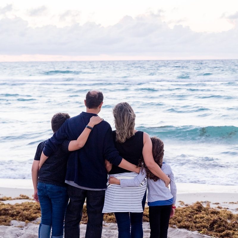 a family of four on a beach